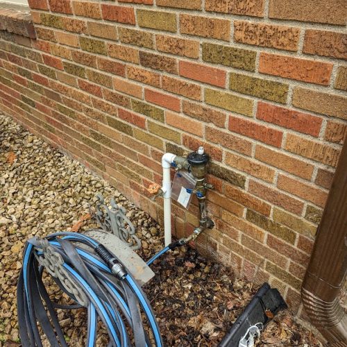 Exterior water line connection with backflow preventer