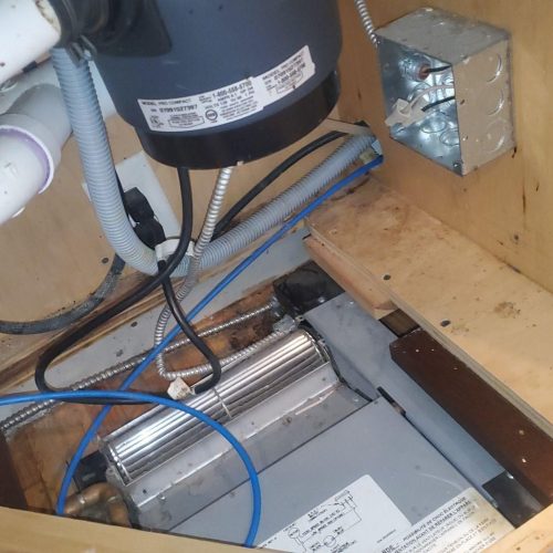 Sump pump motor and PVC discharge lines installed