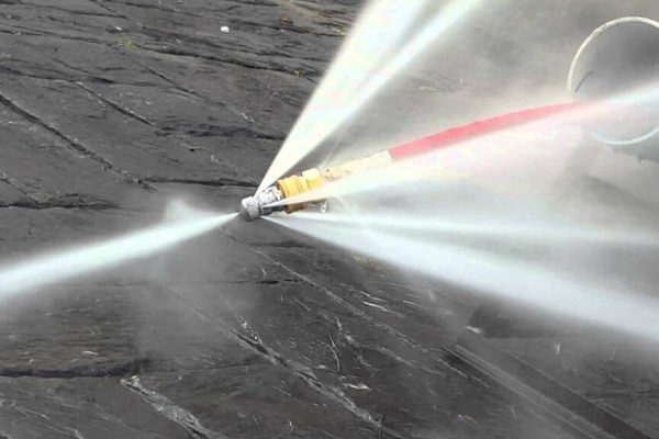Hydro jetting nozzle spraying high-pressure water jets